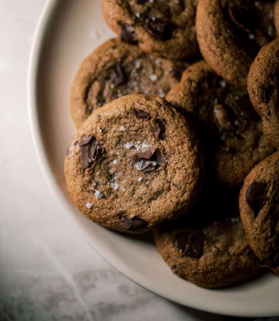 Spelt Chocolate Chunk Cookies on a plate on a countertop.