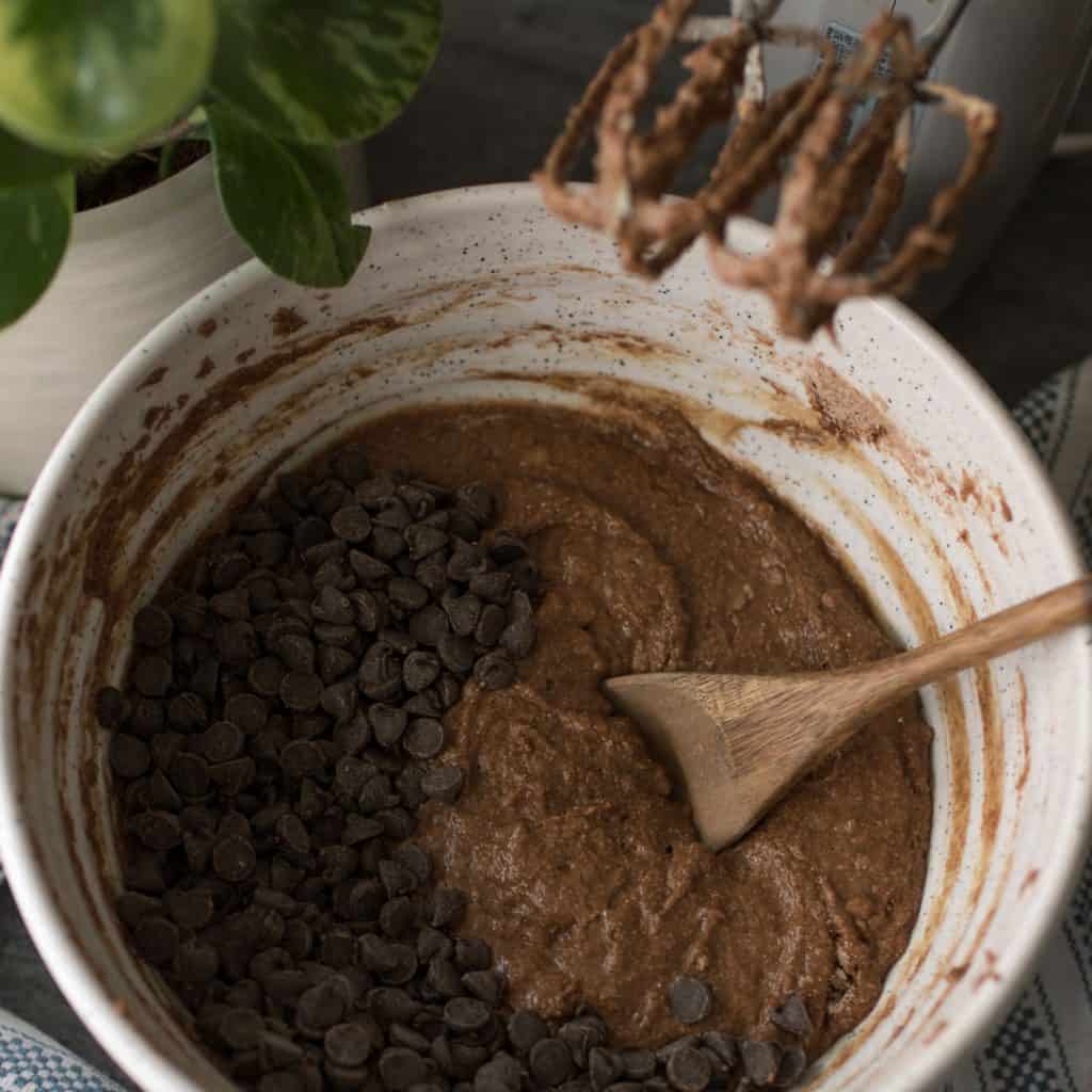 Chocolate chips in a mixing bowl ready to be folded into a batter.