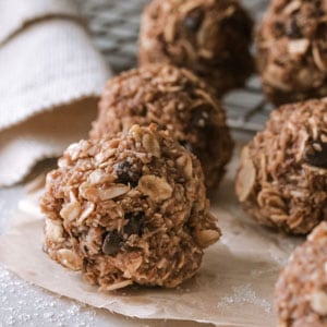 several peanut butter oatmeal energy balls arranged on parchment paper with chocolate chips