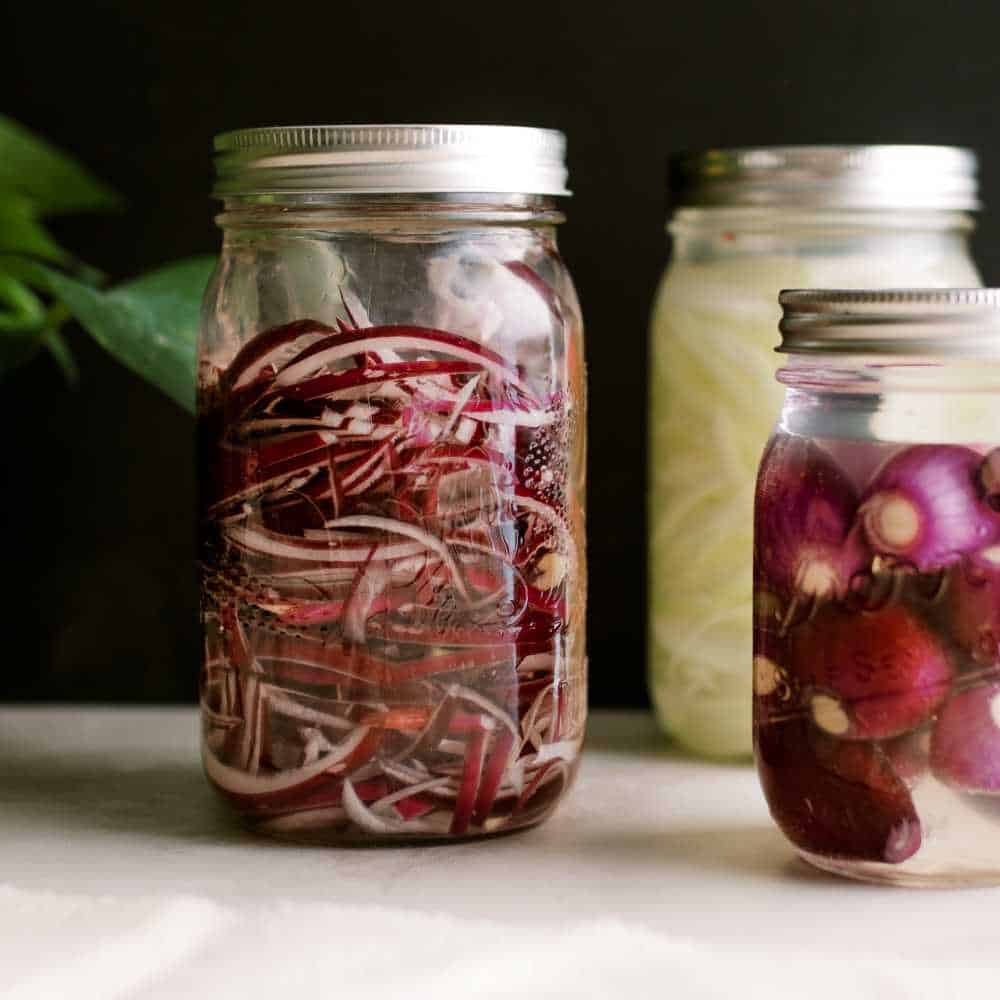 three types of fermented onions in mason jars