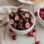 Small bowl full of chocolate covered cranberries.