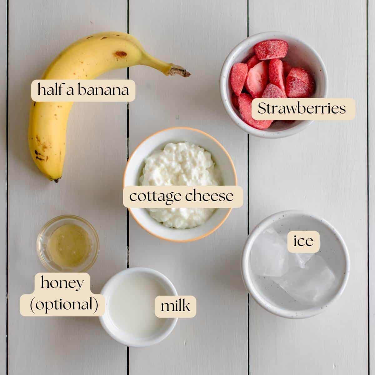 Ingredients you will need: half a banana, strawberries, cottage cheese, ice, milk and honey if so desired.