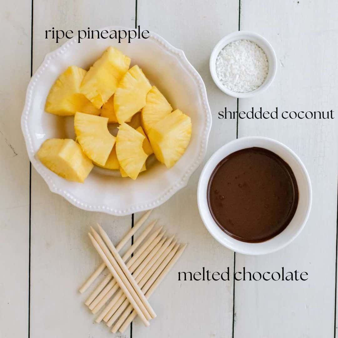 The ingredients required to make chocolate covered pineapple: ripe pineapple, shredded coconut and melted chocolate.