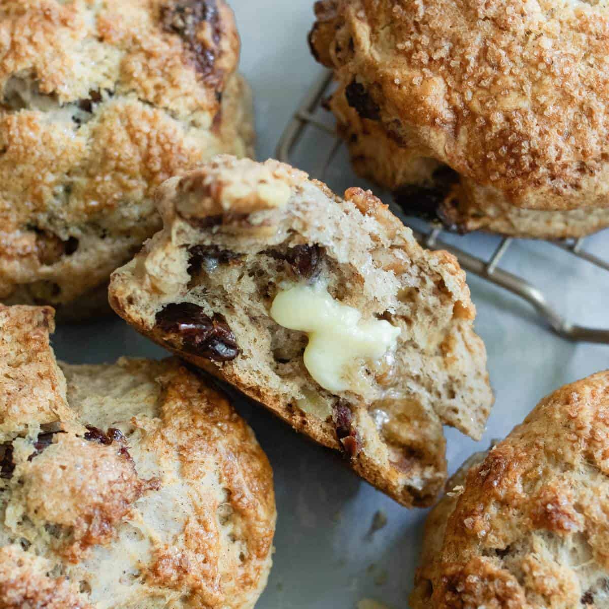 Butter melting on a scone half around other scones.