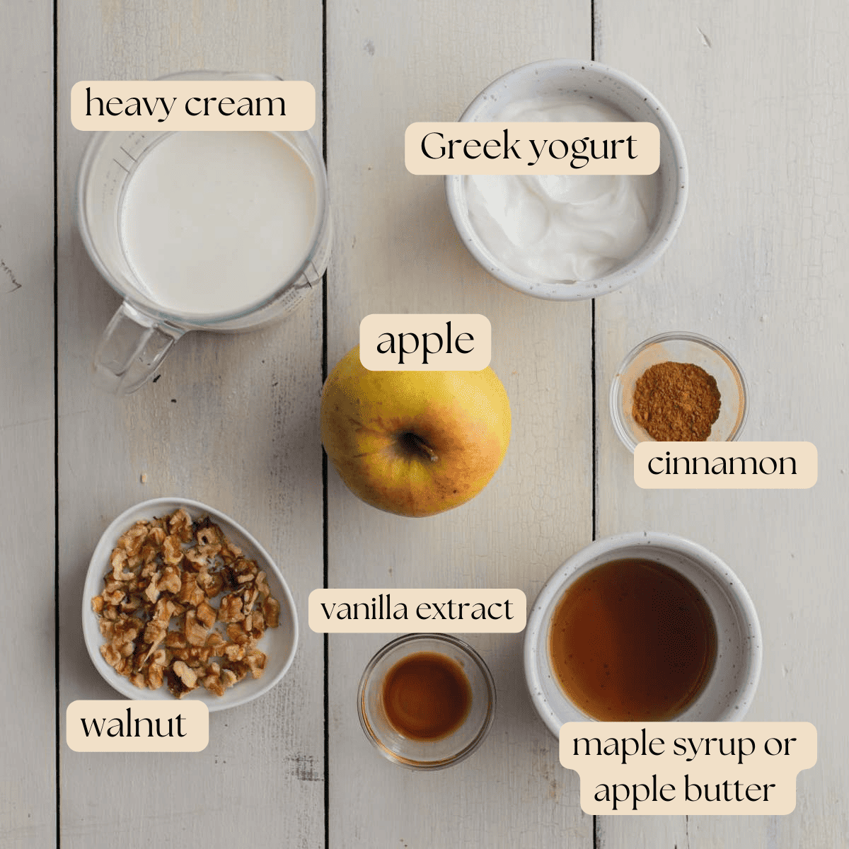Ingredients to make Apple Mousse in mixing bowls, pinch bowls and measuring cups around a whole apple.