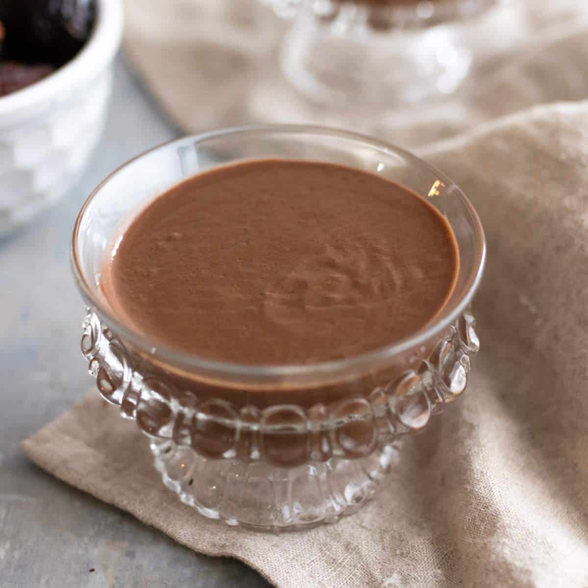 Chocolate pudding in a small glass dessert dish.