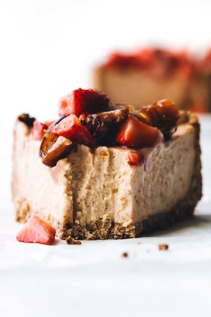 Date cheesecake with chopped dates and strawberries on top.