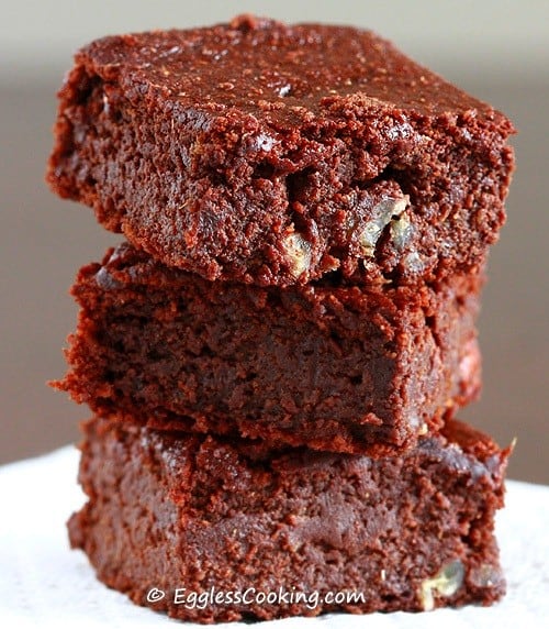 Close-up of three barley brownies stacked on an ornate napkin.