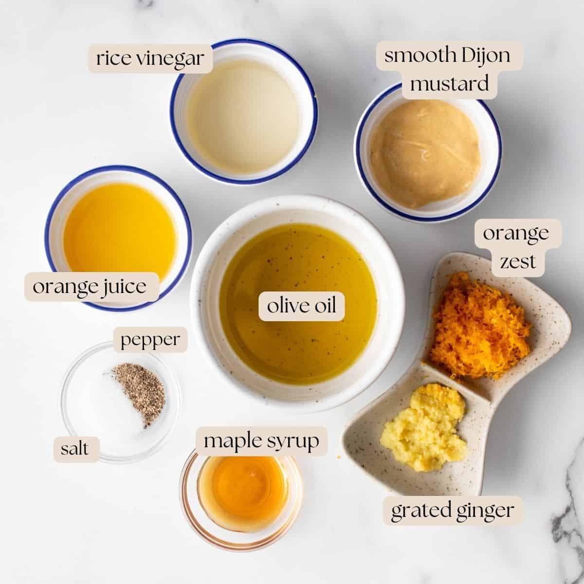 The 9 ingredients you need to make Orange Ginger Vinaigrette in measuring bowls and pinch bowls.