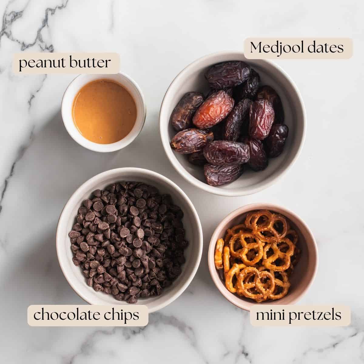 Ingredients to make dark bark in four bowls on a counter.