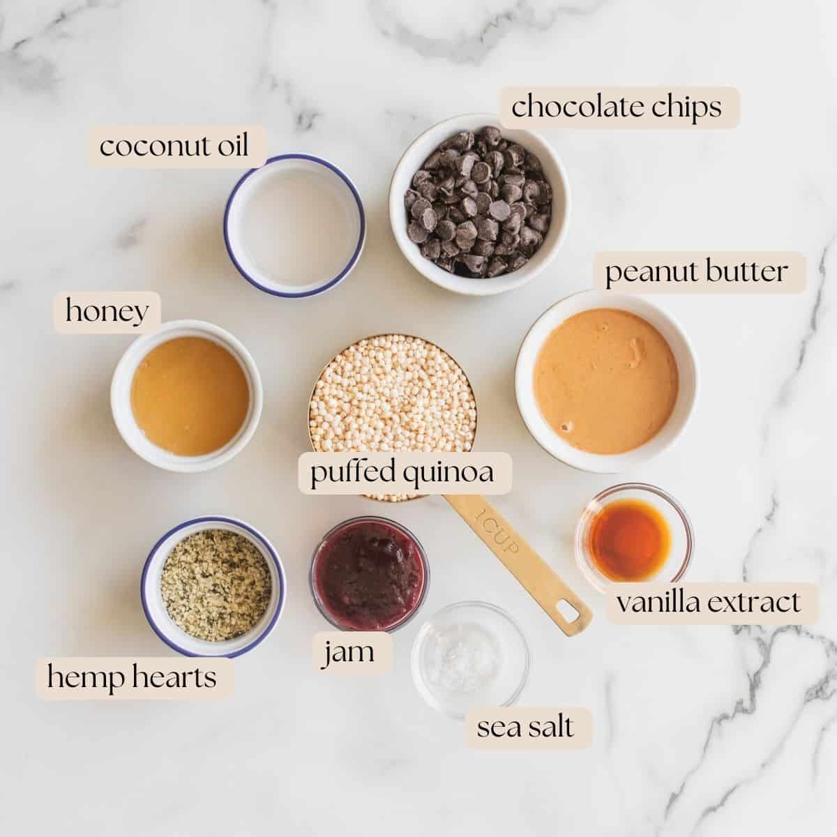 The nine ingredients to make quinoa bites in small bowls and pinch bowls on a counter top.